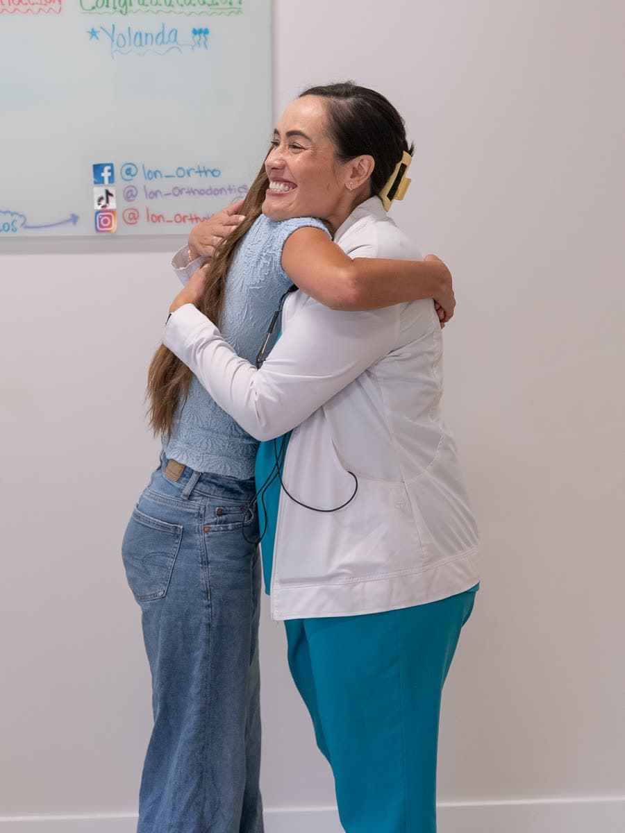 A patient hugging an ION Orthodontics team member after an appointment in Port St. Lucie